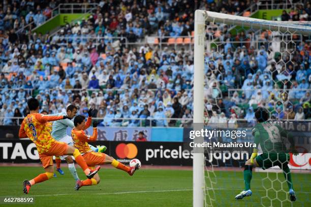 Fozil Musaev of Jubilo Iwata scores his side's second goal past Yuji Rokutan of Shimizu S-Pulse during the J.League J1 match between Jubilo Iwata and...