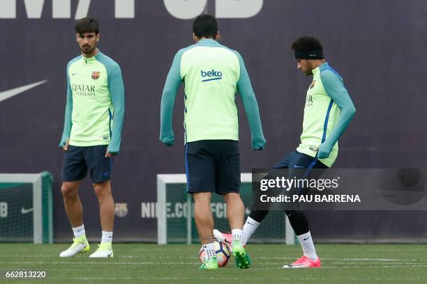 Barcelona's Portuguese midfielder Andre Gomes , Barcelona's Uruguayan forward Luis Suarez and Barcelona's Brazilian forward Neymar take part in a...