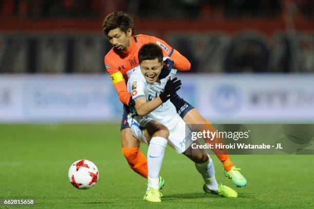 Yuma Suzuki of Kashima Antlers controls the ball under pressure of Kosuke Kikuchi of Omiya Ardija during the J.League J1 match between Omiya Ardija...