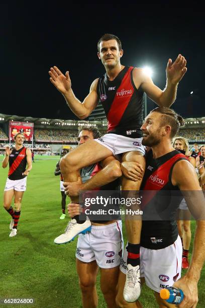 Brent Stanton of the Bombers is chaired from the field after playing his 250th match during the round two AFL match between the Brisbane Lions and...