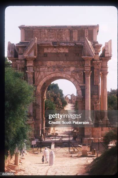 Tourists walk under the Severan Arch September 12, 1999 in Leptis Magna, Libya. Originally established by the Phoenicians in the sixth century BC,...