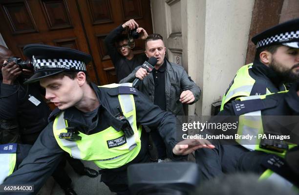 Former spokesman and leader of the English Defence League Tommy Robinson seeks protection from the police near Trafalgar Square in London, during a...