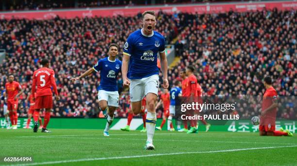 Everton's English defender Matthew Pennington celebrates after scoring their first goal during the English Premier League football match between...