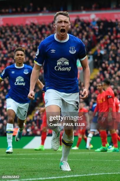 Everton's English defender Matthew Pennington celebrates after scoring their first goal during the English Premier League football match between...