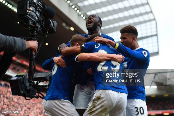 Everton's English defender Matthew Pennington celebrates with Everton's Belgian striker Romelu Lukaku and teammates after scoring their first goal...