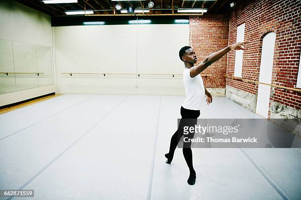 male ballet dancer practicing in dance studio - ballet boy foto e immagini stock
