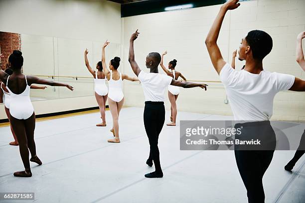 group of young ballet dancers practicing in studio - ballerina ストックフォトと画像
