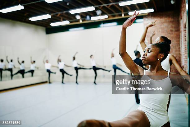 young ballet dancers practicing at barre in studio - ballet black and white stock pictures, royalty-free photos & images