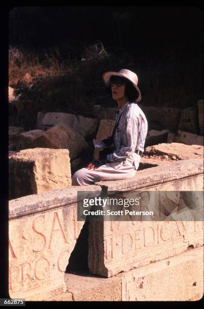 Woman sits on an ancient wall September 12, 1999 in Leptis Magna, Libya. Originally established by the Phoenicians in the sixth century BC, the...