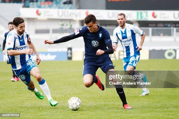 Mattias Bjarsmyr of IFK Goteborg and Alexander Jeremejeff of Malmo FF competes for the ball during the Allsvenskan match between IFK Goteborg and...