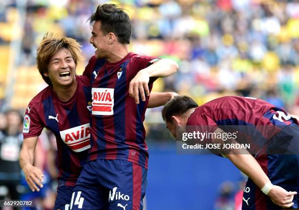 Eibar's Japanese midfielder Takashi Inui celebrates a goal with Eibar's midfielder Daniel Garcia Carrillo during the Spanish league football match...