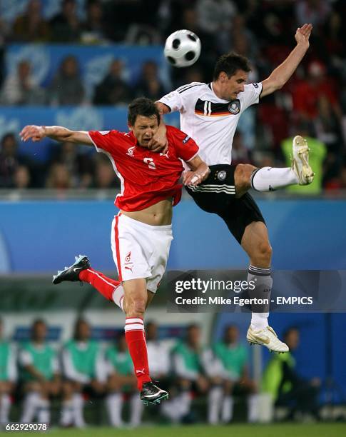 Poland's Dariusz Dudka and Germany's Miroslav Klose battle for the ball