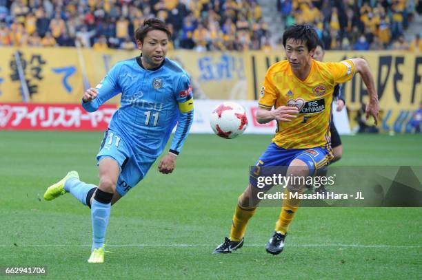 Yu Kobayashi of Kawasaki Frontale and Naoki Ishikawa of Vegalta Sendai compete for the ball during the J.League J1 match between Vegalta Sendai and...