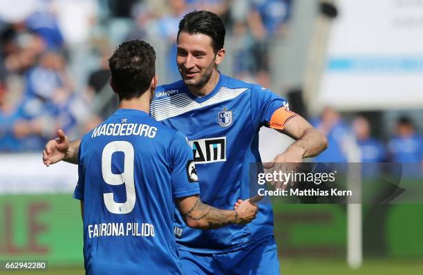 Manuel Farrona Pulido of Magdeburg celebrates with team mate Marius Sowislo after scoring his teams first goal during the third league match between...