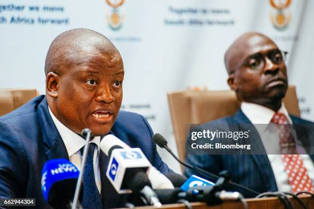 Lungisa Fuzile, director-general of the South Africa National Treasury, left, speaks, as Malusi Gigaba, South Africa's finance minister, looks on...
