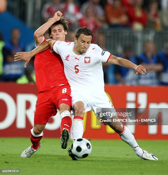 Austria's Christoph Leitgeb and Poland's Dariusz Dudka battle for the ball