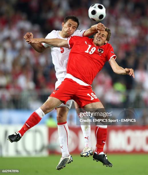 Austria's Jurgen Saumel and Poland's Dariusz Dudka battle for the ball