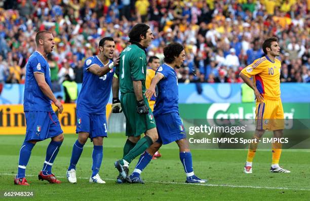 Italy's goalkeeper Gianluigi Buffon celebrates with team mates after saving the penalty from Romania's Adrian Mutu