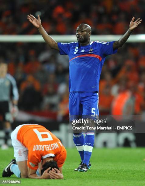 France's William Gallas appeals followig a challenge on Holland's Ruud van Nistelrooy