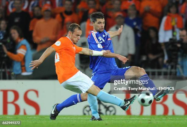 Holland's Wesley Sneijder and France's Jeremy Toulalan battle for the ball