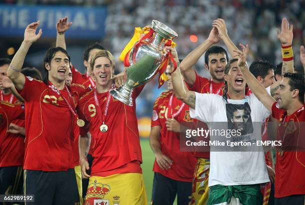 Spain's Garcia Sergio Ramos , Fernando Torres and Ruben De la Red celebrate with the trophy after the final whistle.