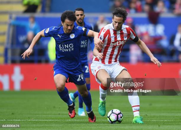 Shinji Okazaki of Leicester City and Ramadan Sobhi of Stoke City battle for possession during the Premier League match between Leicester City and...