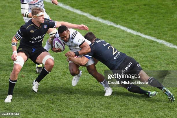 Benito Masilevu of Brive is tackled by Nathan Charles and Tom Ellis of Bath during the European Rugby Challenge Cup Quarter Final match between Bath...