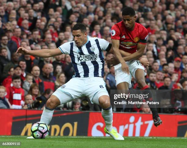 Marcus Rashford of Manchester United in action with Jake Livermore of West Bromwich Albion during the Premier League match between Manchester United...