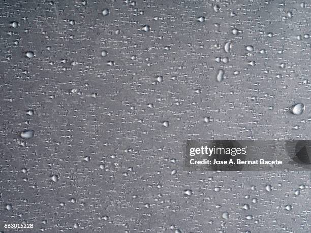 full frame of the textures formed by the bubbles and drops, on a smooth gray background - satén foto e immagini stock