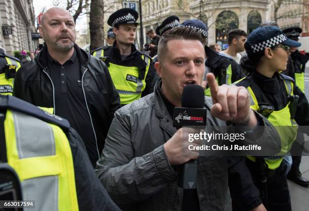 Former English Defence League leader Tommy Robinson is escorted by police during a protest titled 'London march against terrorism' in response to the...