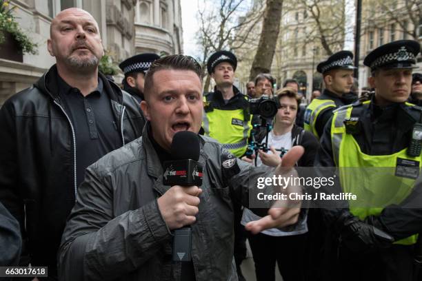 Former English Defence League leader Tommy Robinson is escorted by police during a protest titled 'London march against terrorism' in response to the...