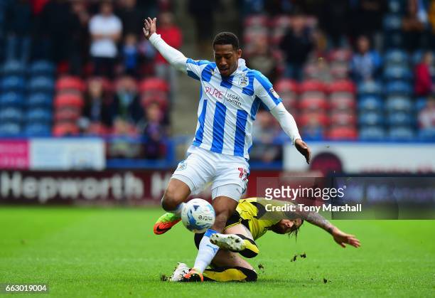 Rajiv Van La Parra of Huddersfield Town is tackled by John Brayford of Burton Albion during the Sky Bet Championship match between Huddersfield Town...