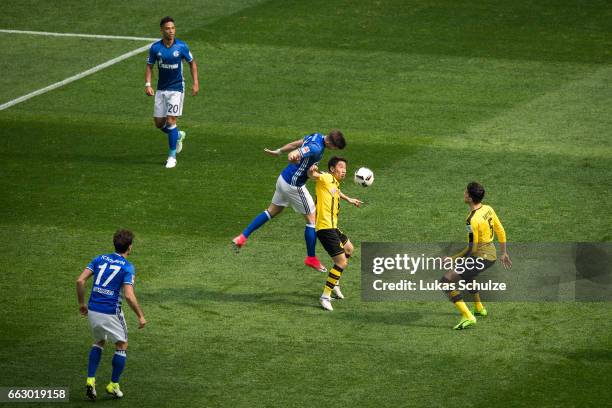 Matija Nastasic of Schalke attacks Shinji Kagawa of Dortmund during the Bundesliga match between FC Schalke 04 and Borussia Dortmund at Veltins-Arena...