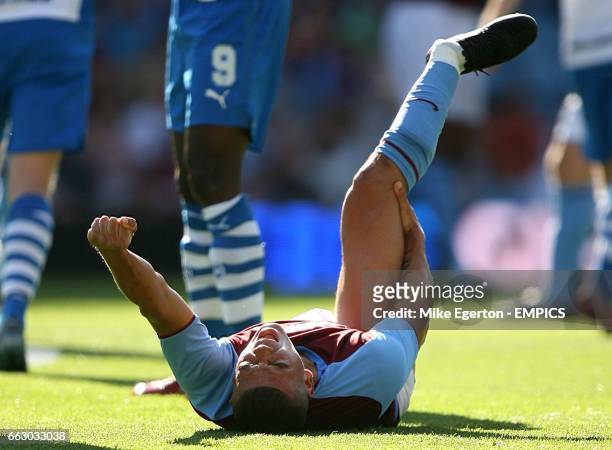 Aston Villa's Wilfred Bouma clutches his leg after dislocating his ankle after a collision with Odense BK's Djilby Fall