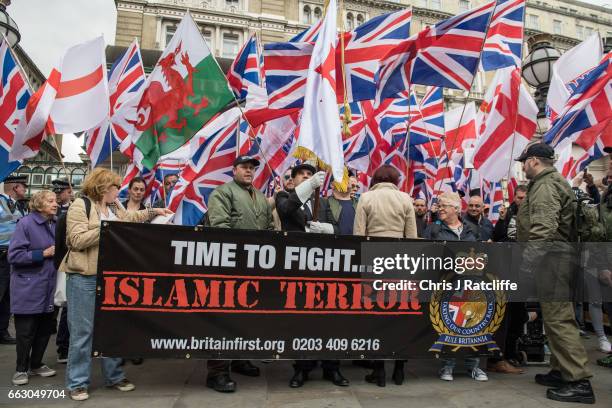 Protesters wave British Union Jack flags during a protest titled 'London march against terrorism' in response to the March 22 Westminster terror...