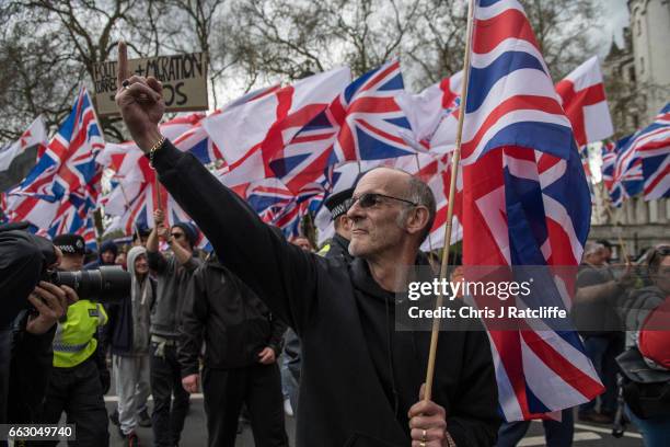 Protester gestures towards members of 'Unite Against Fascism' during a protest titled 'London march against terrorism' in response to the March 22...