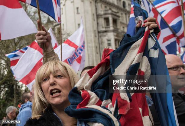Protesters chant and wave British Union Jack flags during a protest titled 'London march against terrorism' in response to the March 22 Westminster...