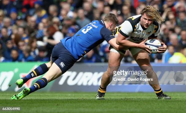 Tommy Taylor of Wasps is tackled by Garry Ringrose during the European Rugby Champions Cup match between Leinster and Wasps at the Aviva Stadium on...