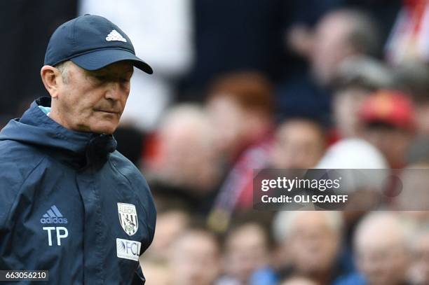 West Bromwich Albion's Welsh head coach Tony Pulis leaves the pitch at half-time during the English Premier League football match between Manchester...