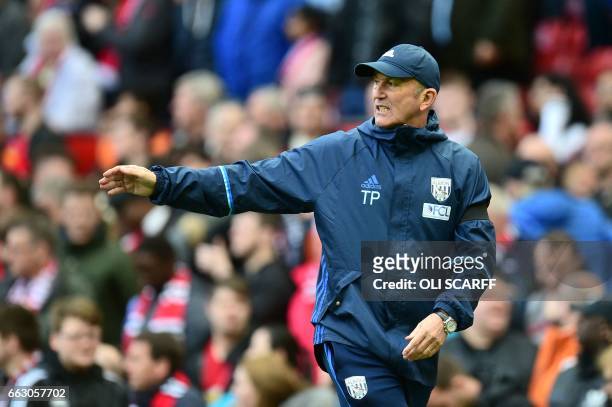 West Bromwich Albion's Welsh head coach Tony Pulis leaves the pitch at half-time during the English Premier League football match between Manchester...