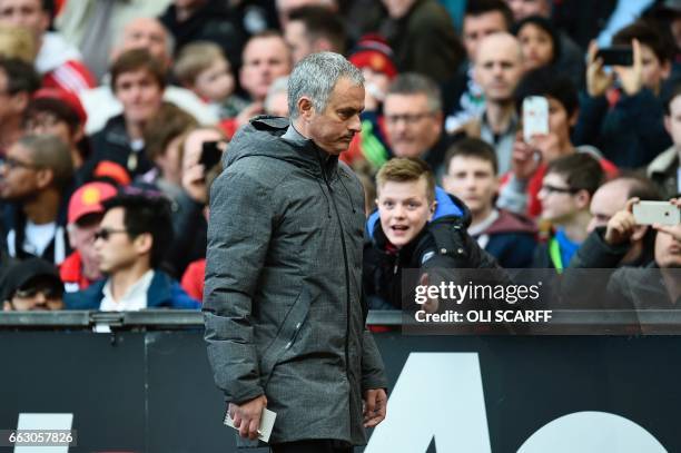 Manchester United's Portuguese manager Jose Mourinho leave the pitch at half-time during the English Premier League football match between Manchester...