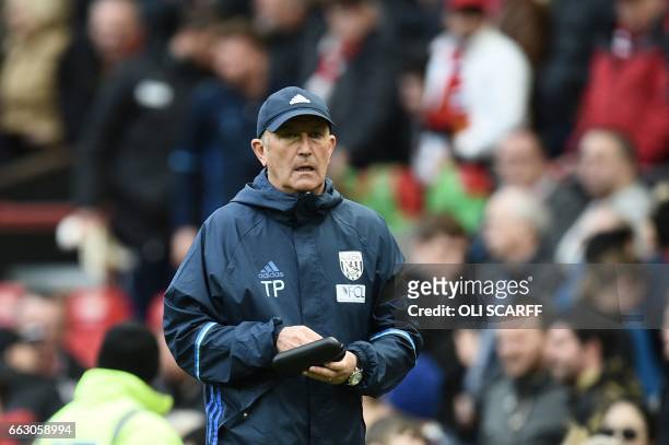 West Bromwich Albion's Welsh head coach Tony Pulis leaves the pitch at half-time during the English Premier League football match between Manchester...
