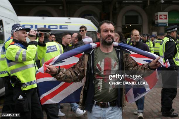 Man joins far-right marches by Britain First and the English Defence League in central London on April 1, 2017. - Members of the Britain First group...