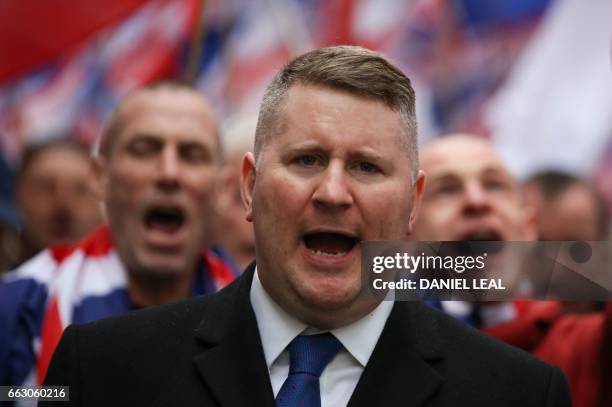 Paul Golding, leader of the far-right organisation Britain First marches in central London on April 1, 2017. - Members of the Britain First group and...