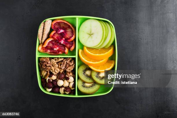 healthy fruits and nuts snack box - portion stock-fotos und bilder