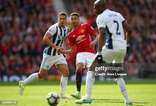 Jesse Lingard of Manchester United beats Jake Livermore and Allan-Romero Nyom of West Bromwich Albion during the Premier League match between...