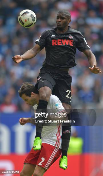 Anthony Modeste of Cologne is challenged by Dennis Diekmeier of Hamburg during the Bundesliga match between Hamburger SV and 1. FC Koeln at...