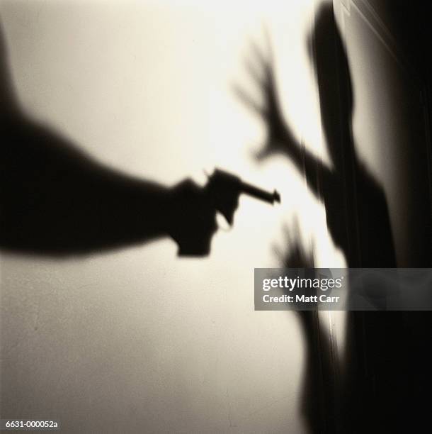 gun in man's hand - hand holding gun stockfoto's en -beelden