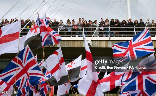 Members of the public are held on a bridge while Britain First and English Defence League protesters take part in a demonstration in London.