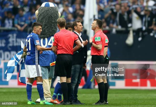 Head coach Markus Weinzierl of Schalke discusses with referee Felix Zwayer after the Bundesliga match between FC Schalke 04 and Borussia Dortmund at...